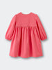 Coral pink dress with long sleeves on a light gray background Button Through Dress - Cloudberry Girls