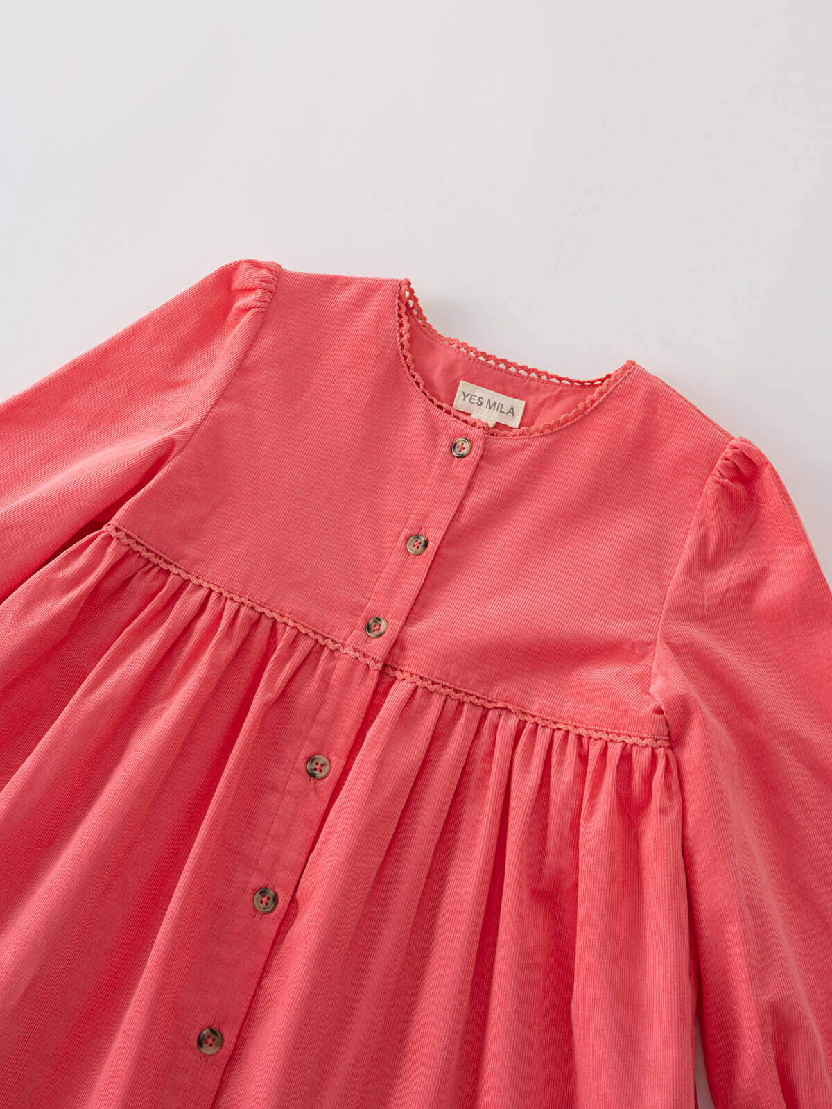 coral pink dress with button details on a light gray background Button Through Dress - Cloudberry Girls