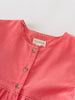 Close-up of a coral pink dress with 'YES MILA' label on a light gray background Button Through Dress - Cloudberry Girls