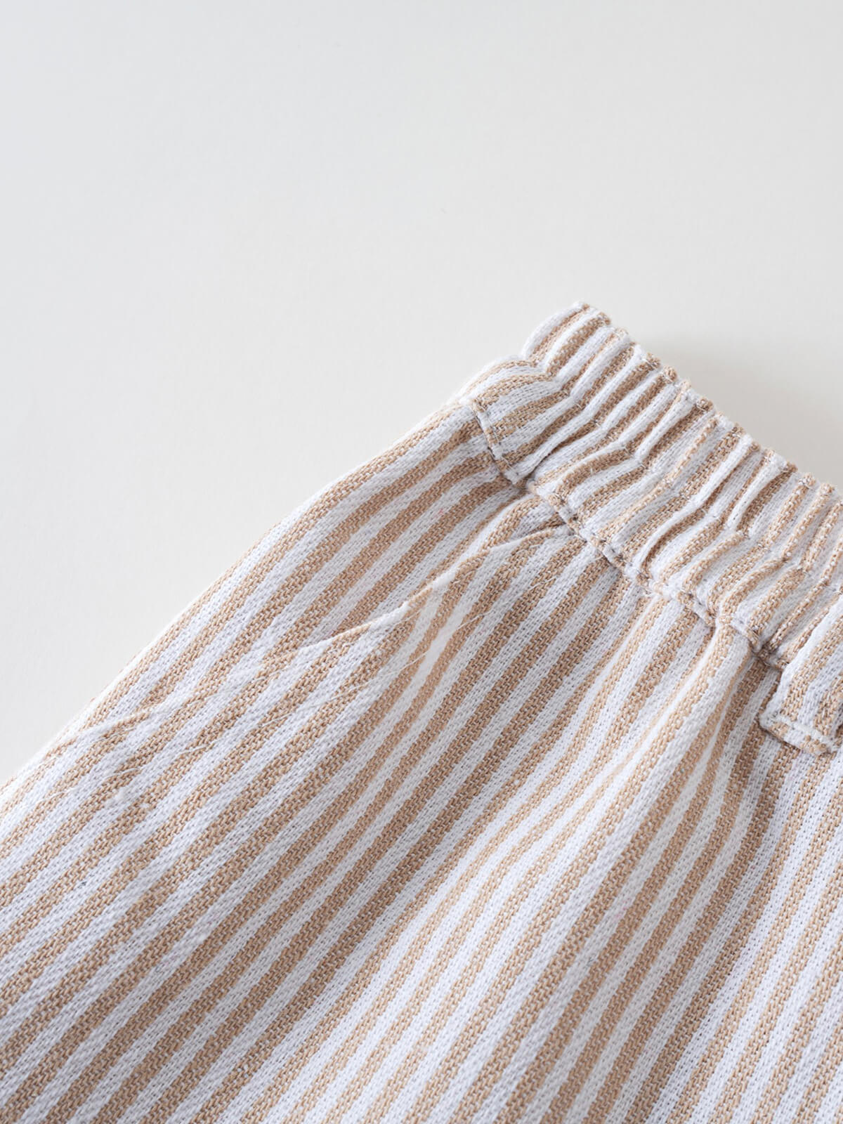 Close-up of striped elastic waistband pants with drawstring in beige and white Cargo Pants - Sand Stripe Boys
