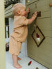 Child playing with a wooden playhouse door Carter Towelling Shorts - Sand Baby boy