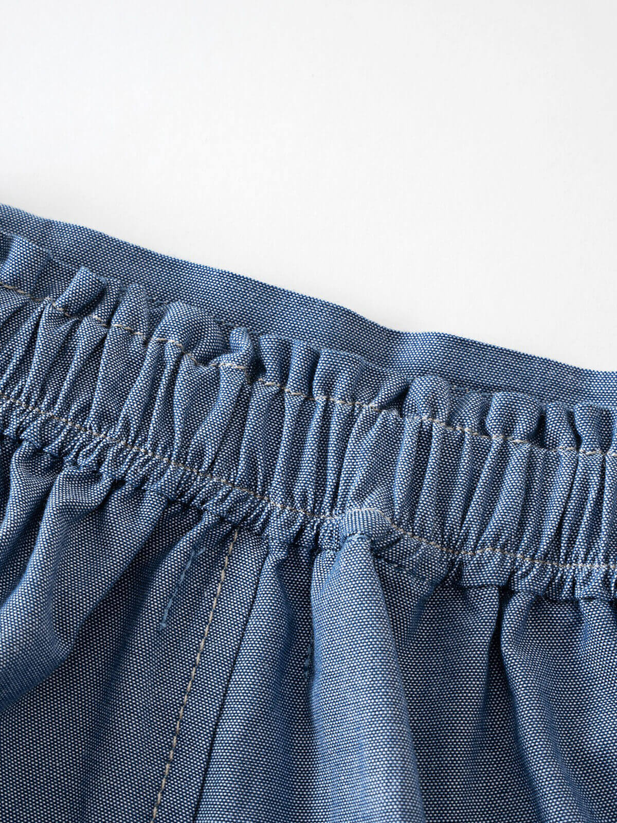 Close-up of gathered elastic waistband on blue chambray fabric shorts Chambray Shorts - Blue Chambray Girls