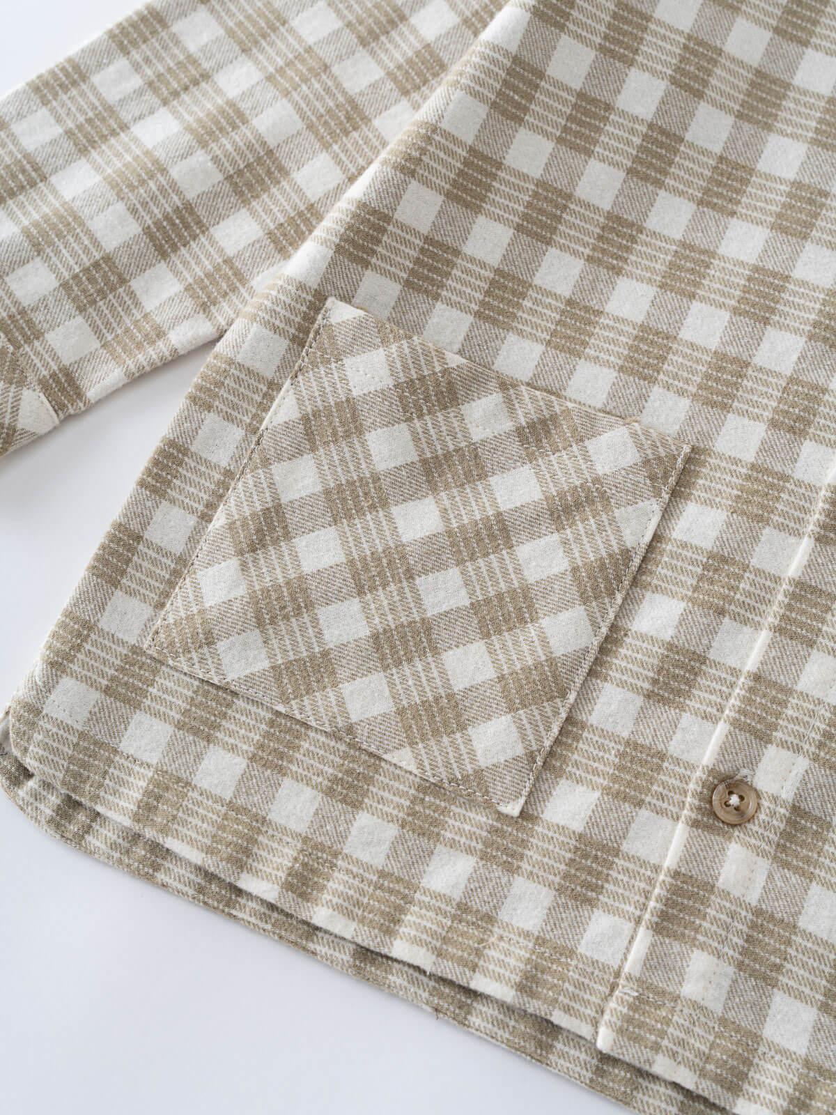 Close-up of a brown and white shirt fabric with a pocket and button on a white background Check Shirt - Brushed Cotton Check Boys