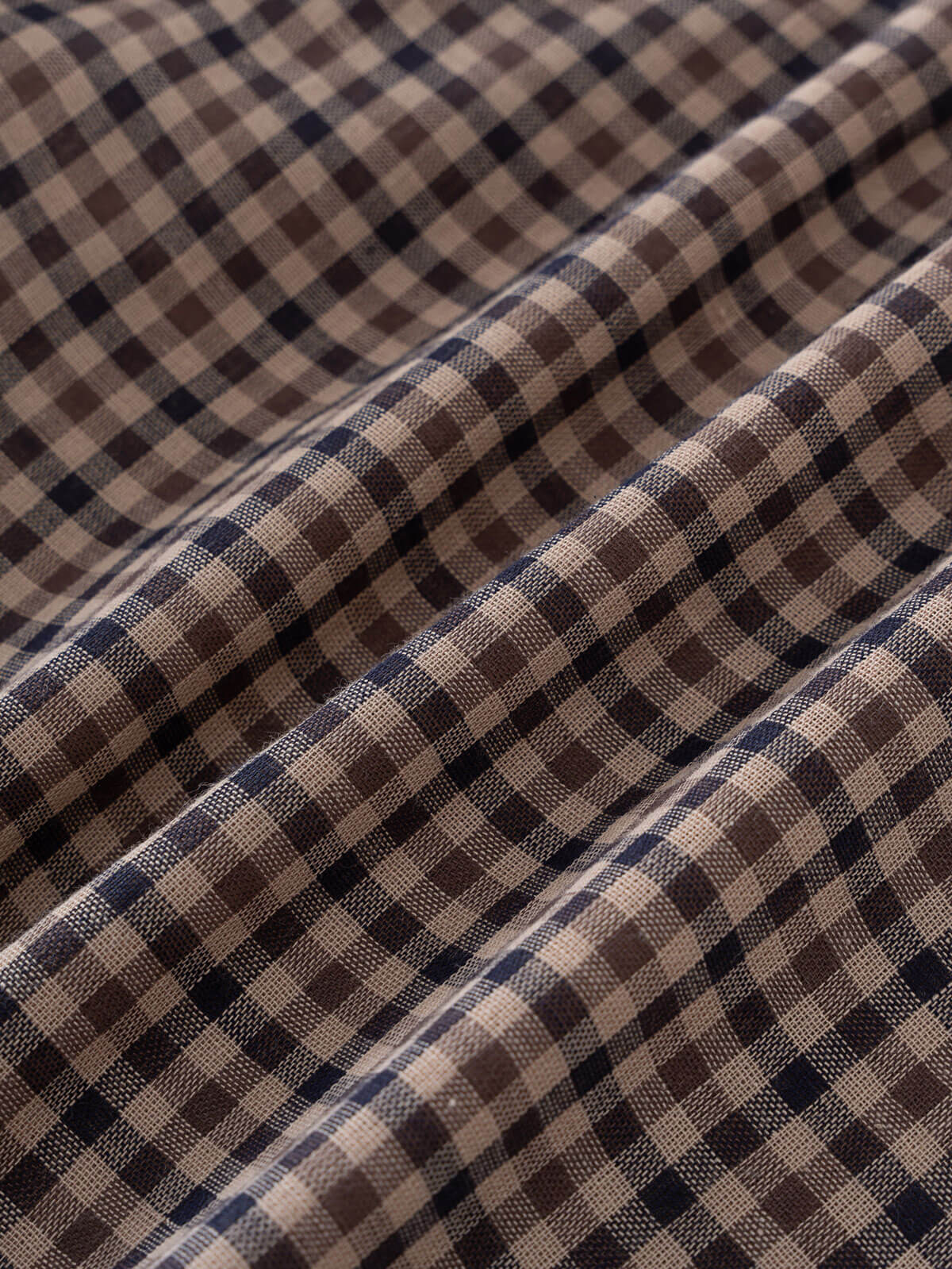 Close-up of checkered shirt fabric with brown, beige, and blue pattern Check Shirt - Muslin Cotton Check Boys