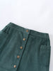 Green corduroy skirt with button details on a white background