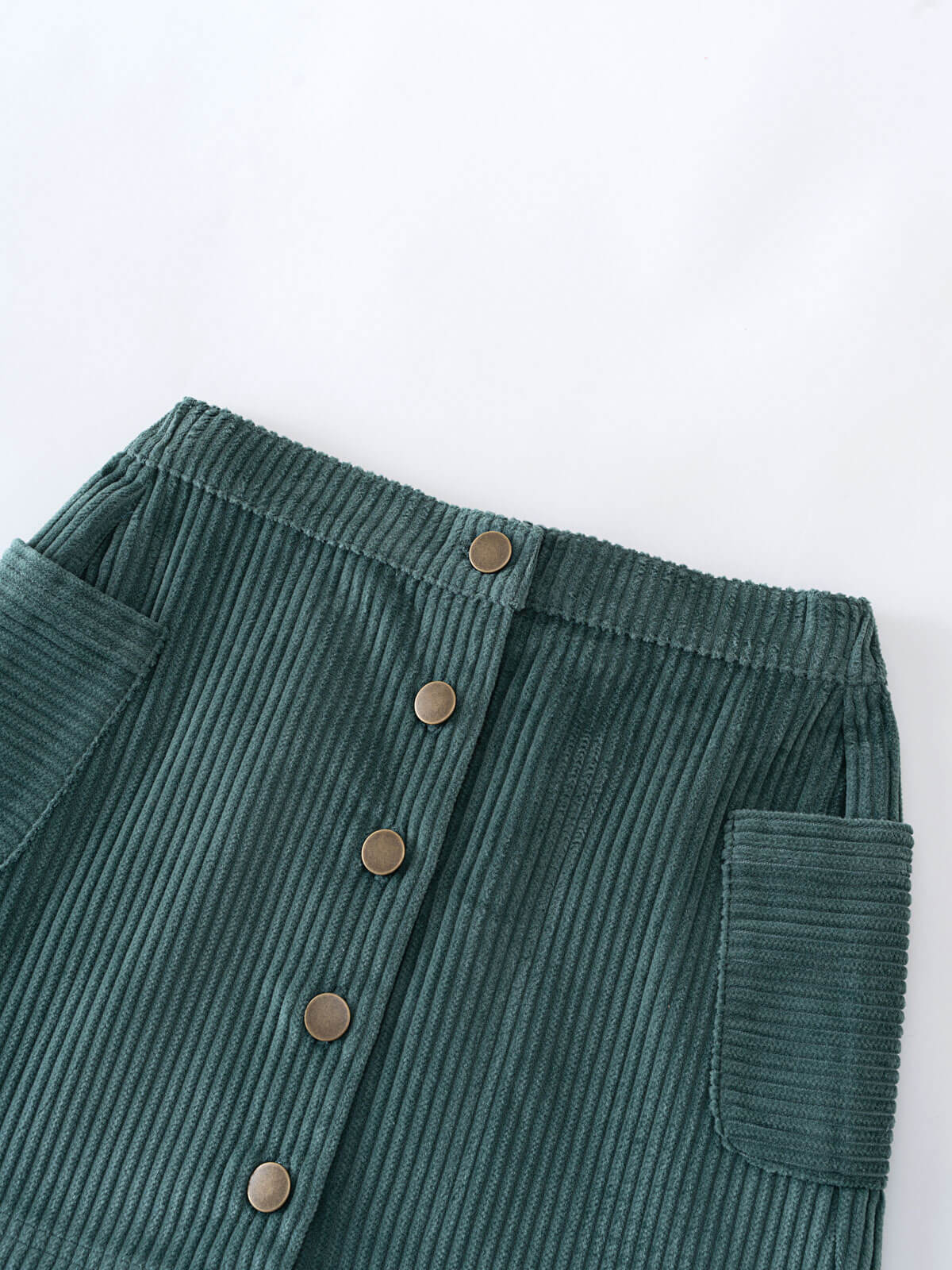 Green corduroy skirt with button details on a white background