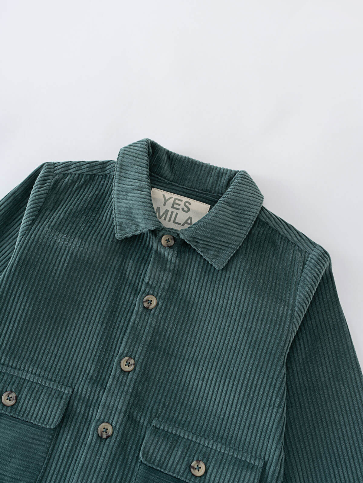 Close-up of a teal corduroy jacket with buttons and chest pockets Corduroy Jacket - Balsam Girls and Boys