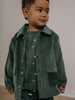 Child wearing a green corduroy jacket and shirt with a plain background Corduroy Jacket - Balsam Girls and Boys