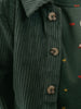 Close-up of a green corduroy jacket with buttons and a patterned background Corduroy Jacket - Balsam Girls and Boys