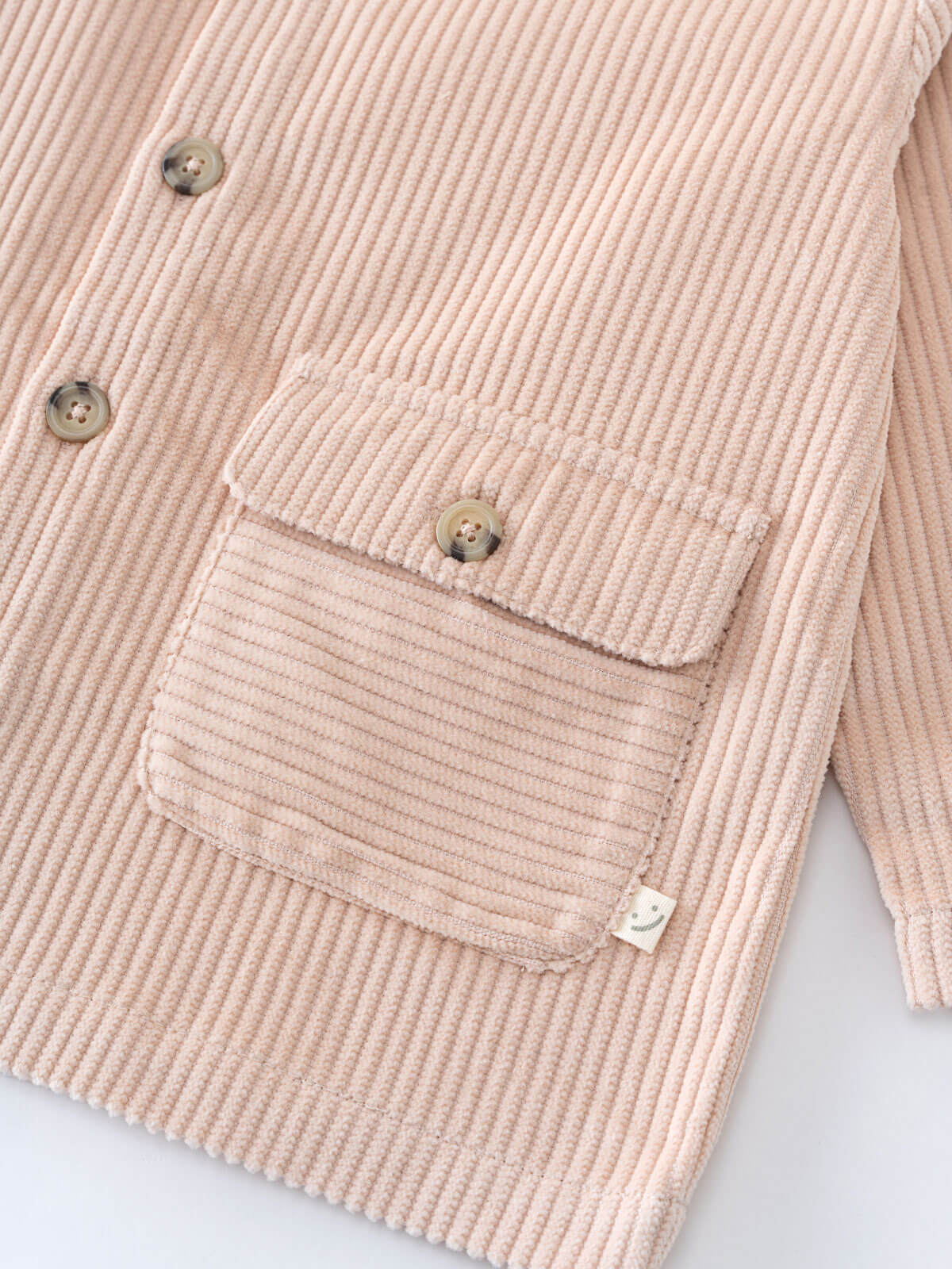 Close-up of a beige corduroy jacket with button details on a light background Corduroy Jacket - Clay Girls and Boys