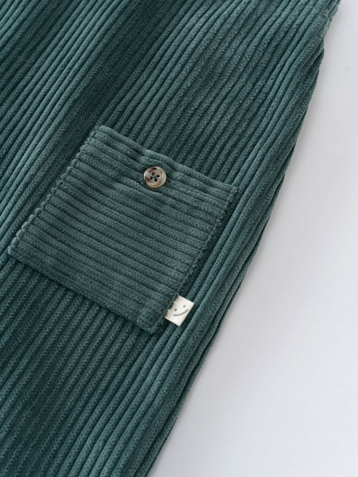 Green corduroy overalls  with a pocket on a light gray background Corduroy Overalls - Balsam Baby boy