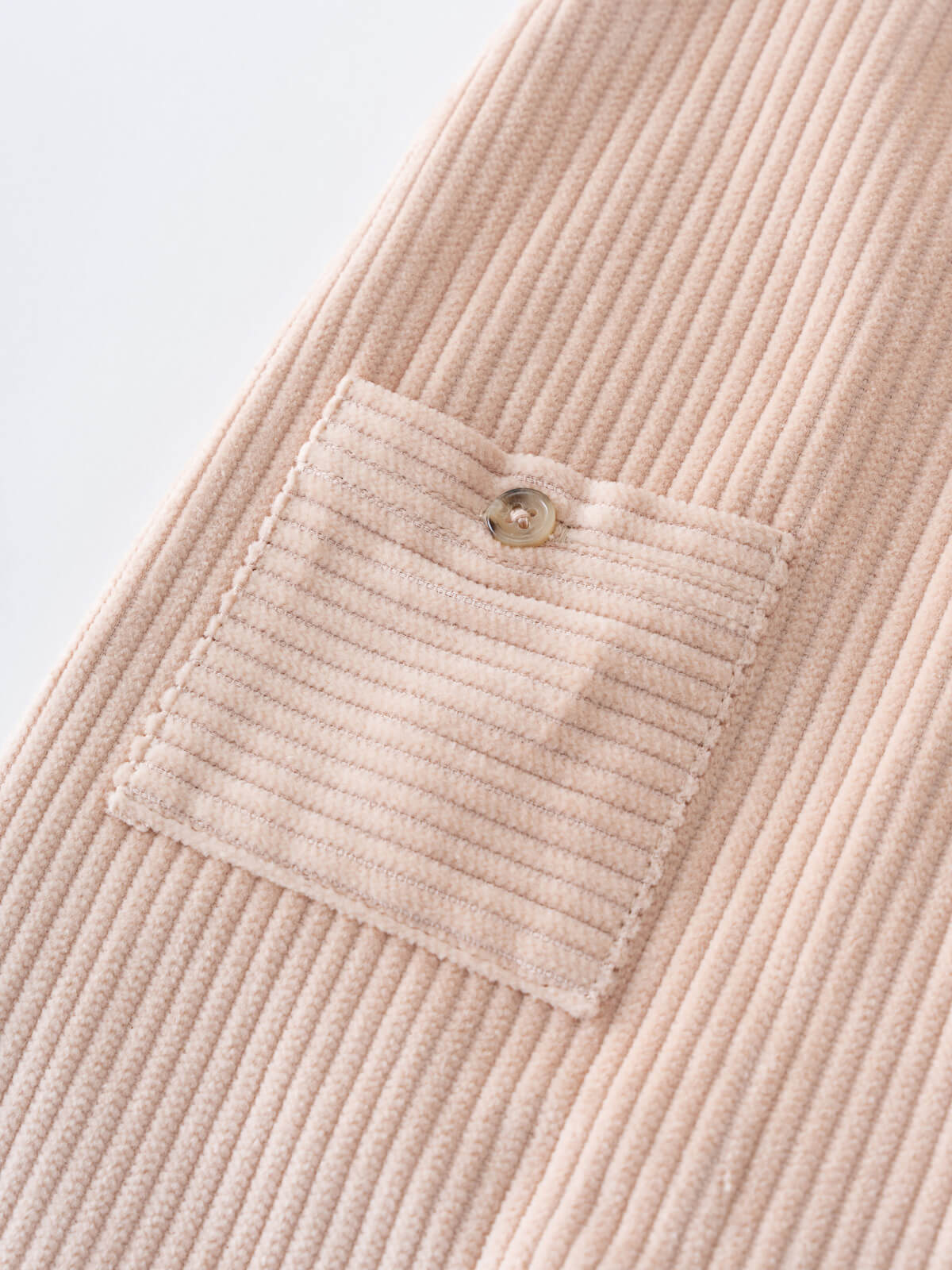Close-up of a beige corduroy overalls with a pocket on a light gray background Corduroy Overalls - Clay Baby boy