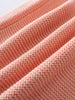 Close-up of peachy pink knitted fabric with textured folds Cotton Cardigan - Toasted Peach Baby girl