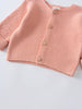 Close-up of a pink knitted cardigan with wooden buttons Cotton Cardigan - Toasted Peach Baby girl