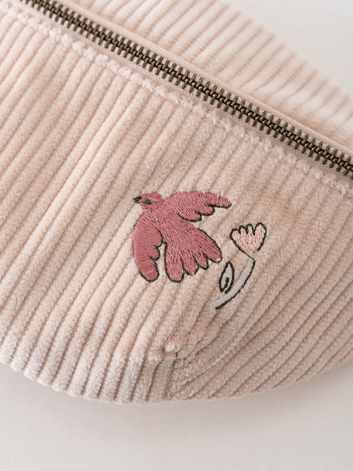 Pink corduroy waist bag with pink embroidered design on a light background Crossbody Bag - Dove Girls
