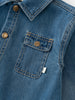 Close-up of a blue denim jacket with a pocket and buttons. Denim Jacket - Blue Denim Girls and Boys
