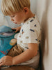 Child reading a book with a soft, warm background