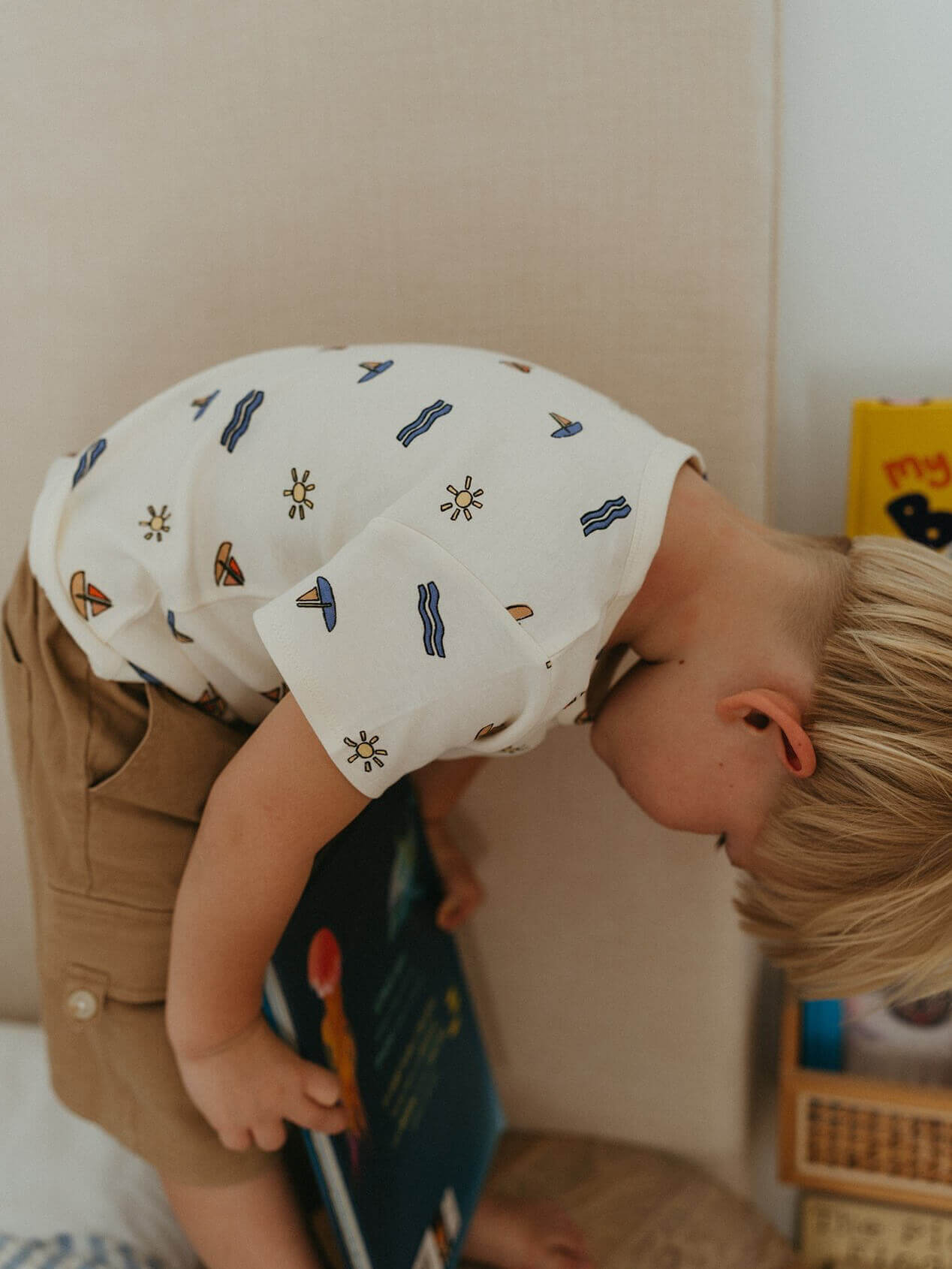 Child playing with a toy on a bed