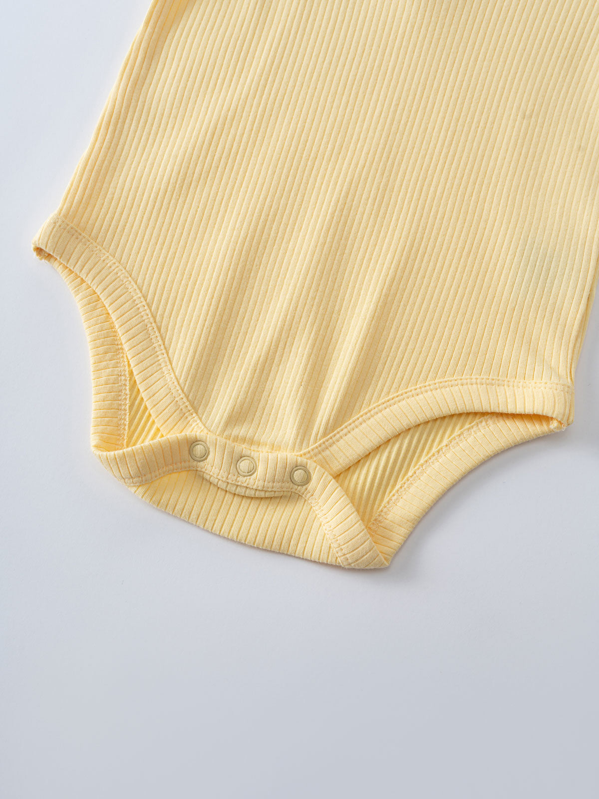 Close-up of a yellow ribbed bodysuit with snap closures at the bottom Henley Short Sleeve Bodysuit- Sun Soaked Baby girl