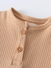 Close-up of beige ribbed fabric with wooden buttons near neckline Henley Short Sleeve Bodysuit - Sand Baby boy