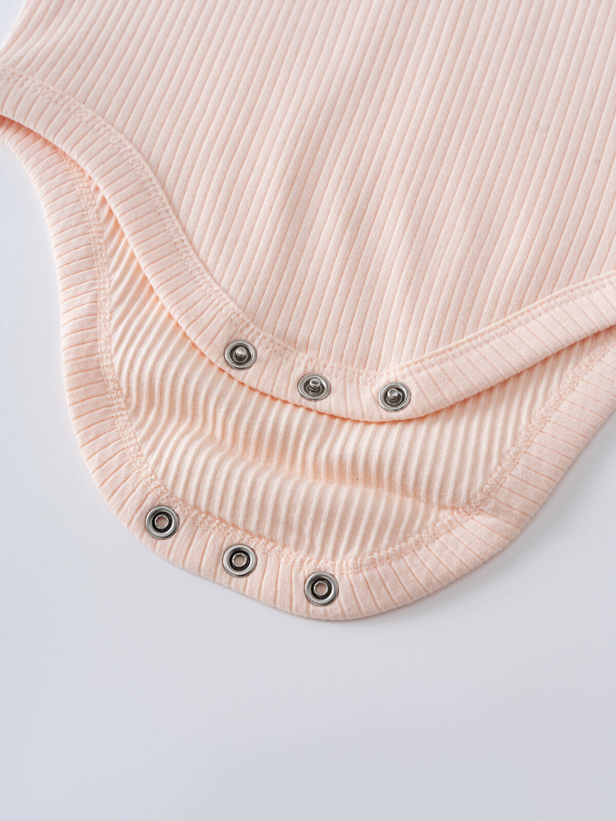 Close-up of pink ribbed fabric bodysuit with metal snap buttons Henley Short Sleeve Bodysuit- Shell Pink Baby girl
