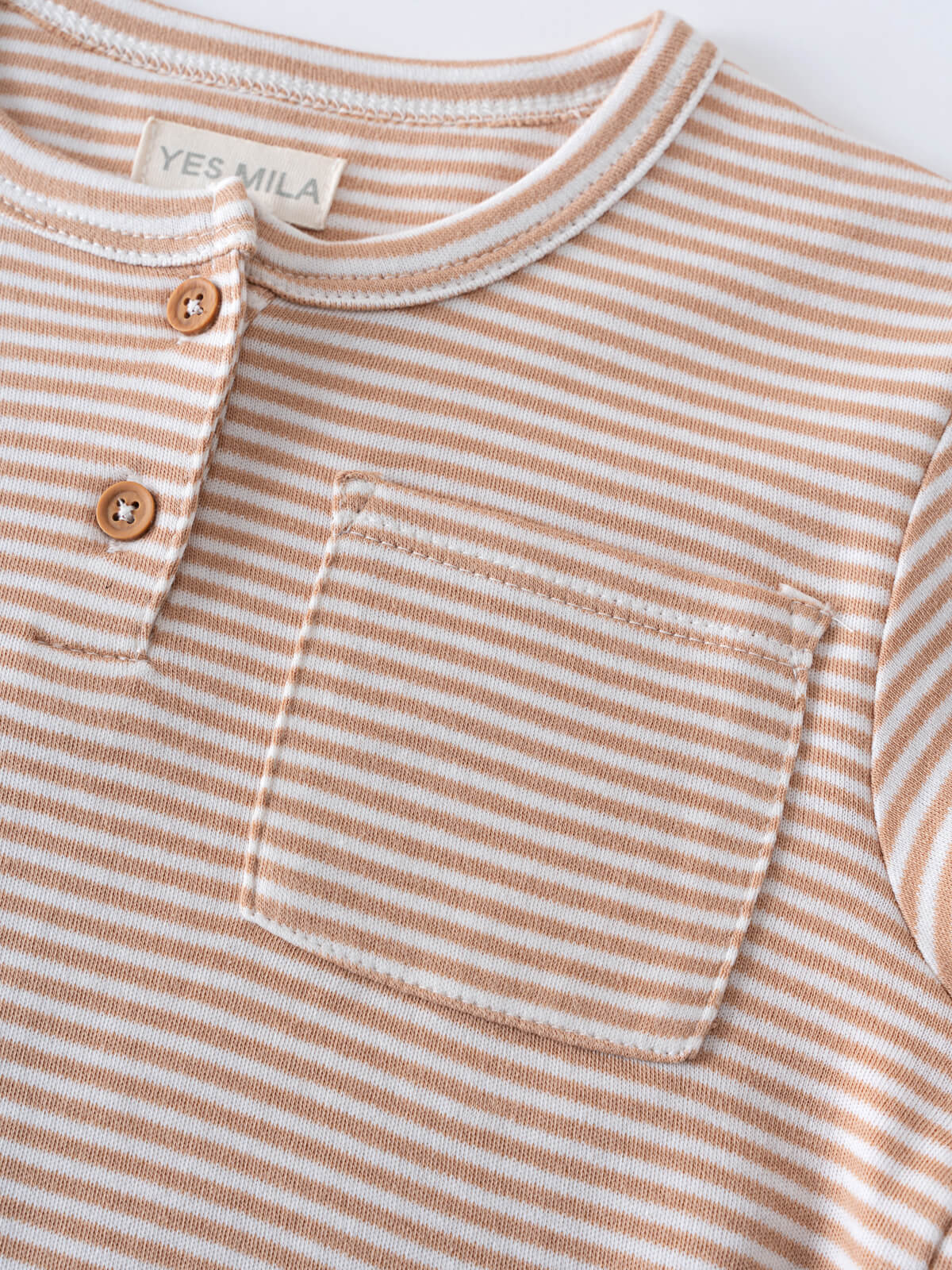 Close-up of a striped shirt with two brown buttons and chest pocket Henley Tee - Sand Stripe Boys