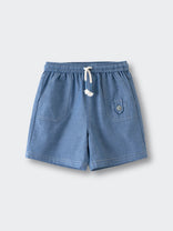 Blue chambray shorts with white drawstring and front pockets laid flat Hudson Shorts - Blue Chambray Boys