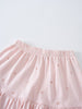 Close-up of a pale pink gathered skirt with small floral embroidery Jersey Skirt - Spring Love Girls