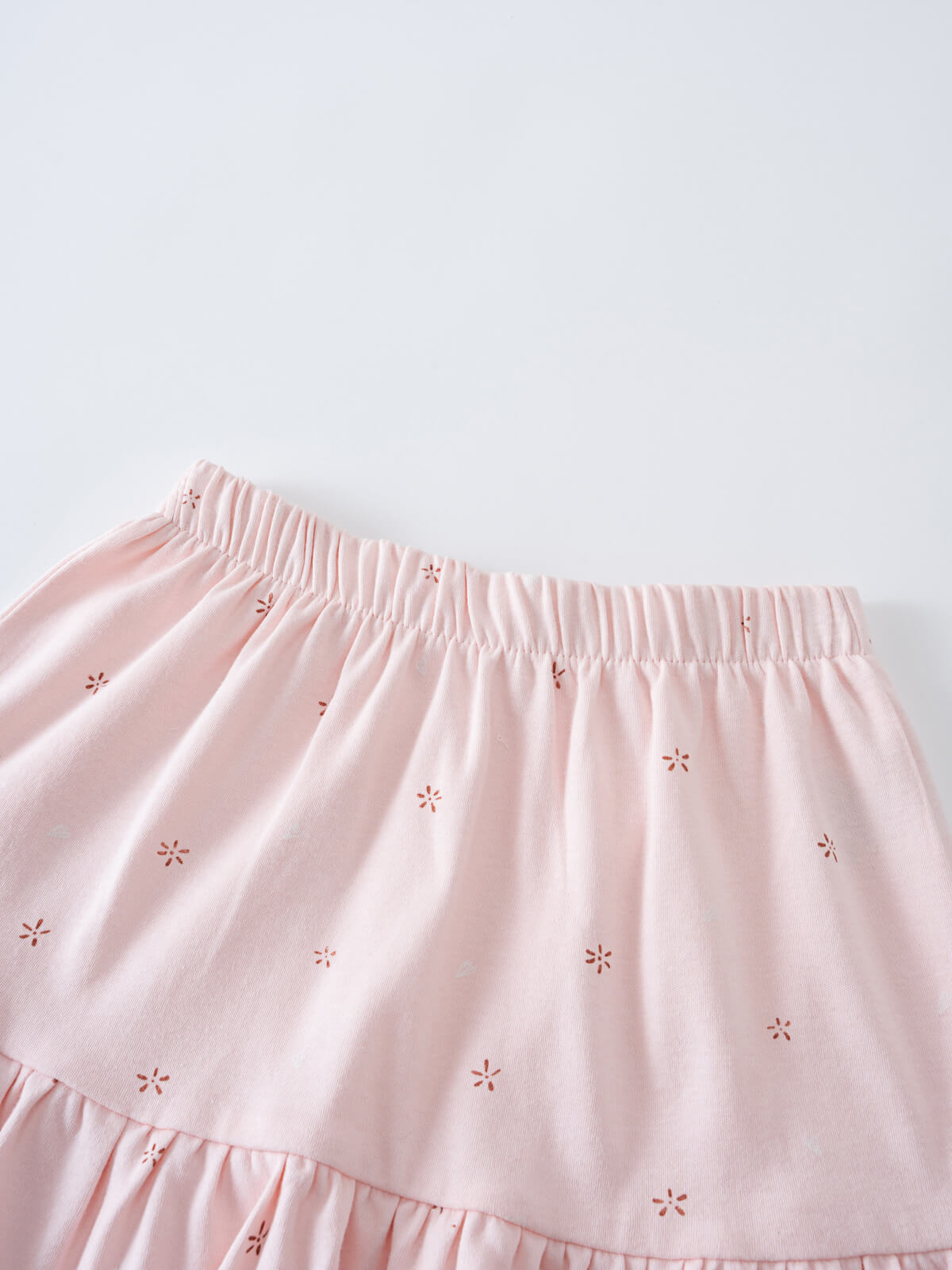 Close-up of a pale pink gathered skirt with small floral embroidery Jersey Skirt - Spring Love Girls