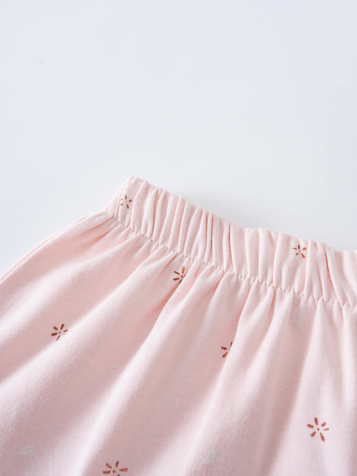 Close-up of pink fabric skirt with elastic waistband and floral embroidery details Jersey Skirt - Spring Love Girls