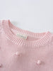 Close-up of a pink knitted sweater with visible brand label on neckline Knit Jumper - Candy Floss Girls