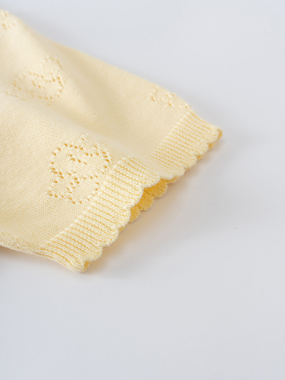 Close-up of pale yellow knit garment with ribbed cuffs and decorative stitching Knit Tee - Sun Soaked Girls