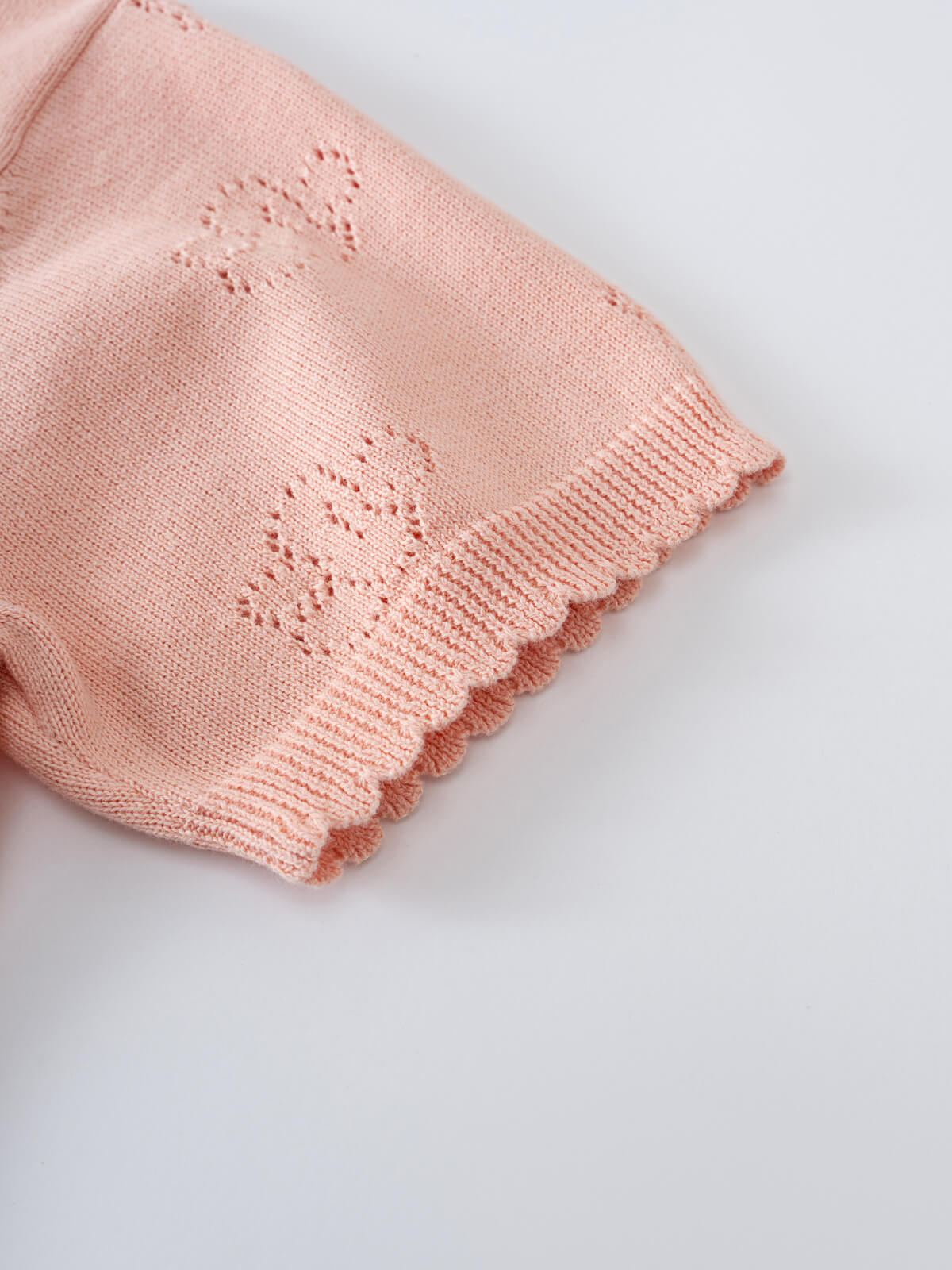 Close-up of pink knitted sleeve with decorative eyelet detail and ribbed cuff Knit Tee - Toasted Peach Girls