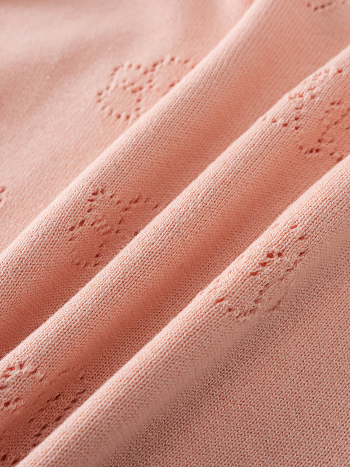 Close-up of pink knitted fabric with textured eyelet detailing and soft folds Knit Tee - Toasted Peach Girls