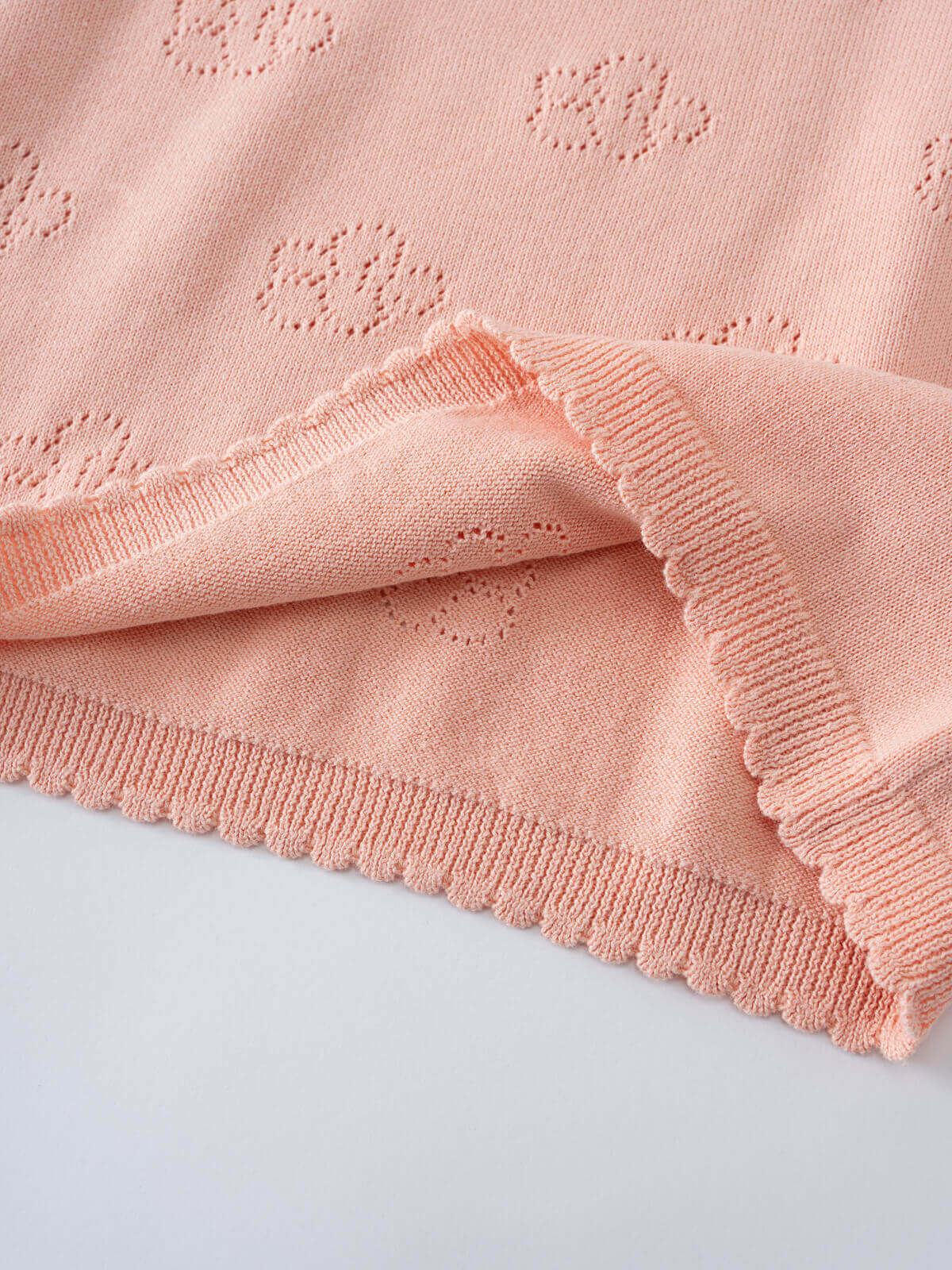 Close-up of pink knitted fabric with eyelet detail and scalloped trim Knit Tee - Toasted Peach Girls