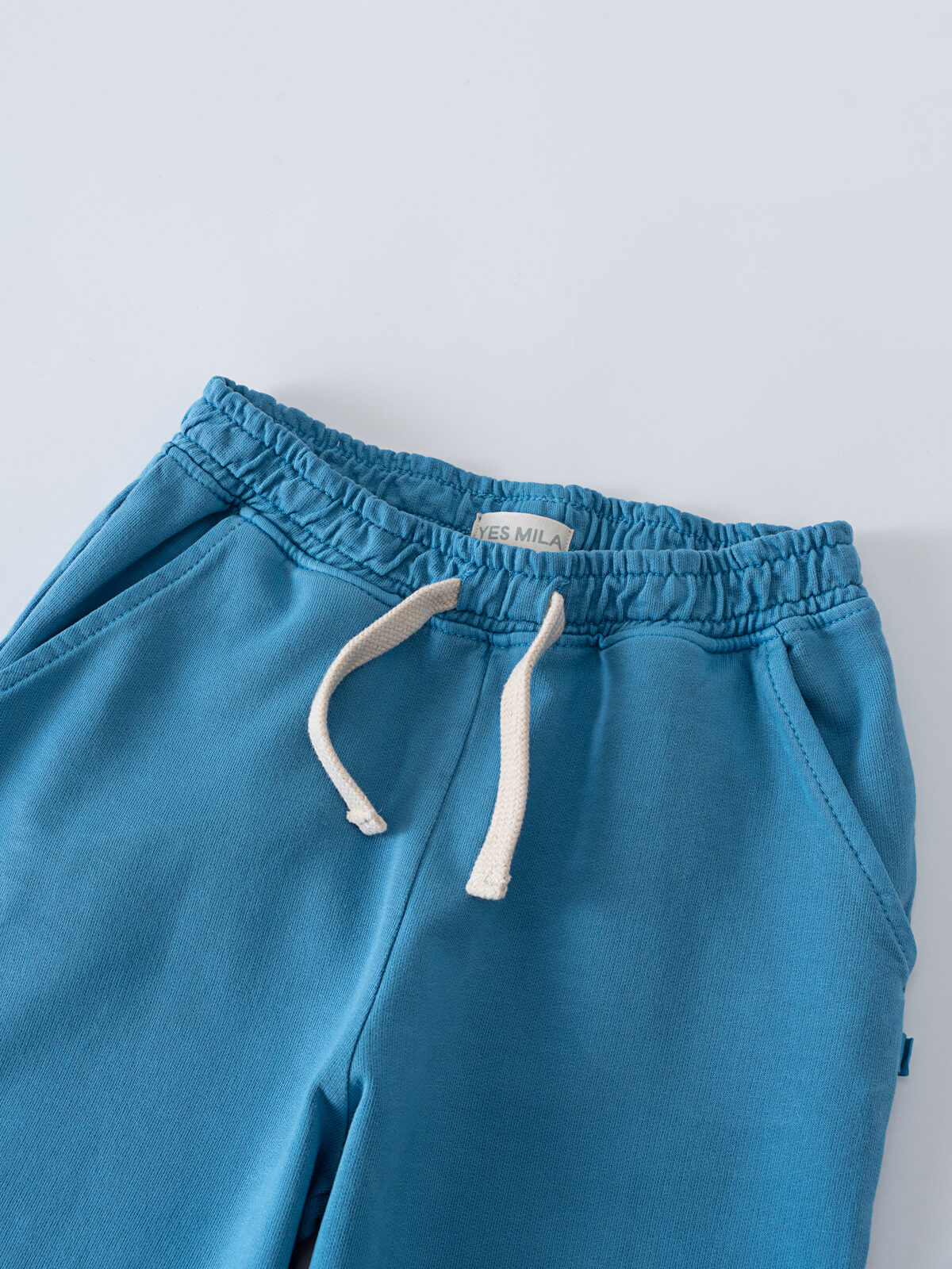 Blue sweatpants with white drawstring and elastic waistband on gray surface Light Sweatpants - Marine Boys