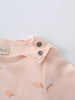 Close-up of a pale pink baby bodysuit with snap buttons and apple print Long Sleeve Bodysuit - Apples Baby girl