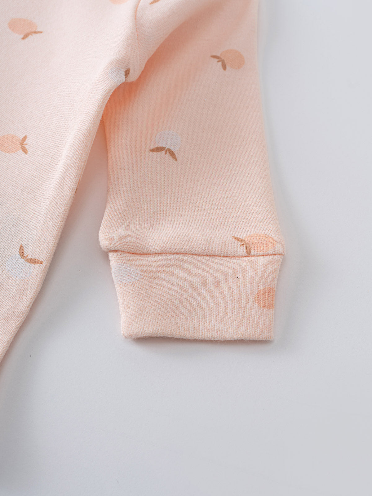 Close-up of a pale pink sleeve with apple print pattern and ribbed cuff Long Sleeve Bodysuit - Apples Baby girl