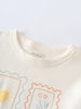Close-up of cream-colored tee collar with illustrated frames containing sun and flowers Long Sleeve Tee - Sunny Club Day Girls