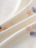 Close-up of cream fabric with purple shells and orange starfish print Lottie Short Sleeve Dress - Beach Shells Girls