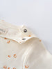 Close-up of cream bodysuit with orange print and snap buttons Matt Short Sleeve Bodysuit - Sailing Baby boy