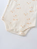 Close-up of cream baby bodysuit with small orange sailboat print and snap closure Matt Short Sleeve Bodysuit - Sailing Baby boy
