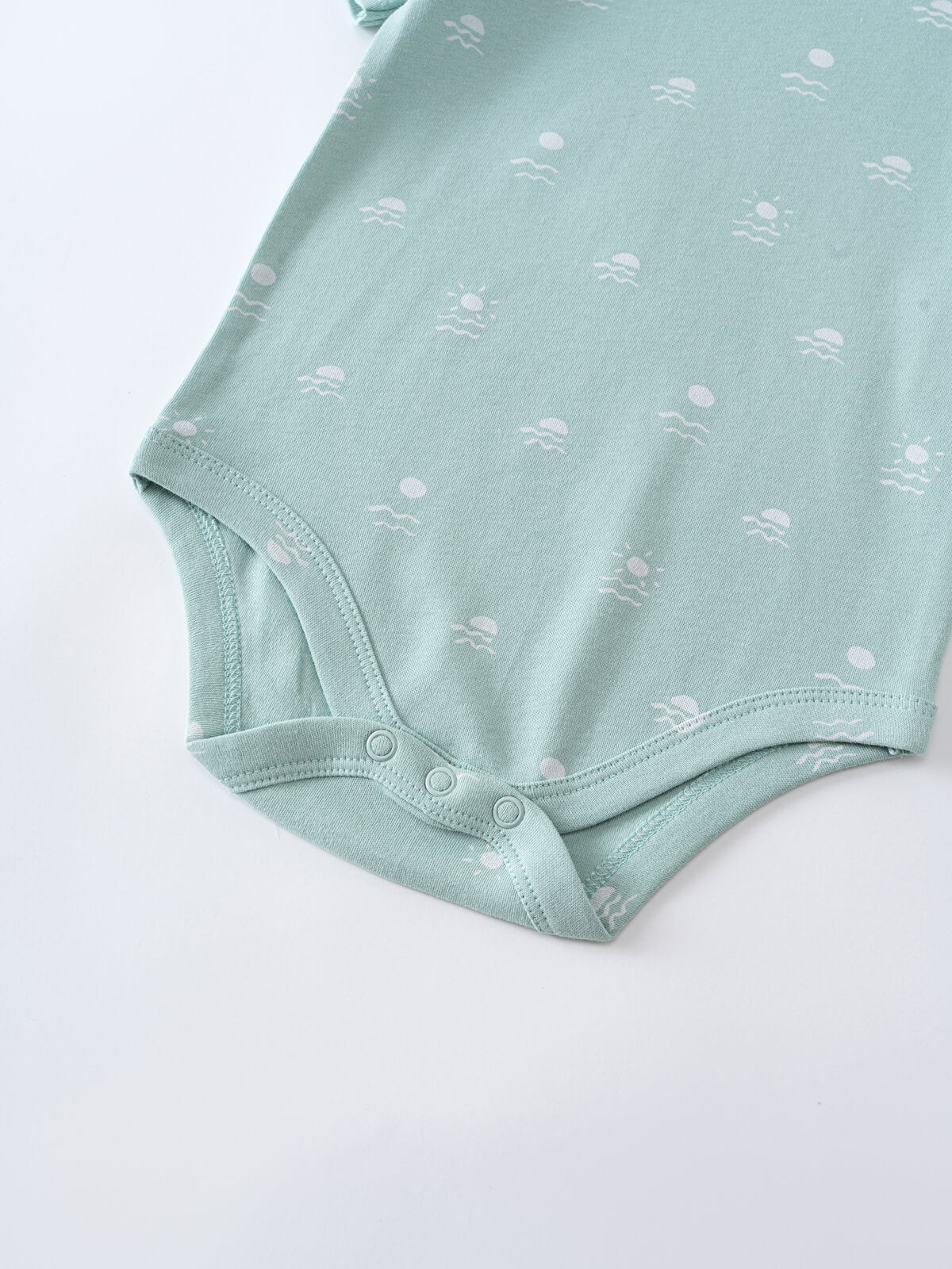 Close-up of mint green baby bodysuit with white printed pattern and snap closures Matt Short Sleeve Bodysuit - Summer Time Baby boy