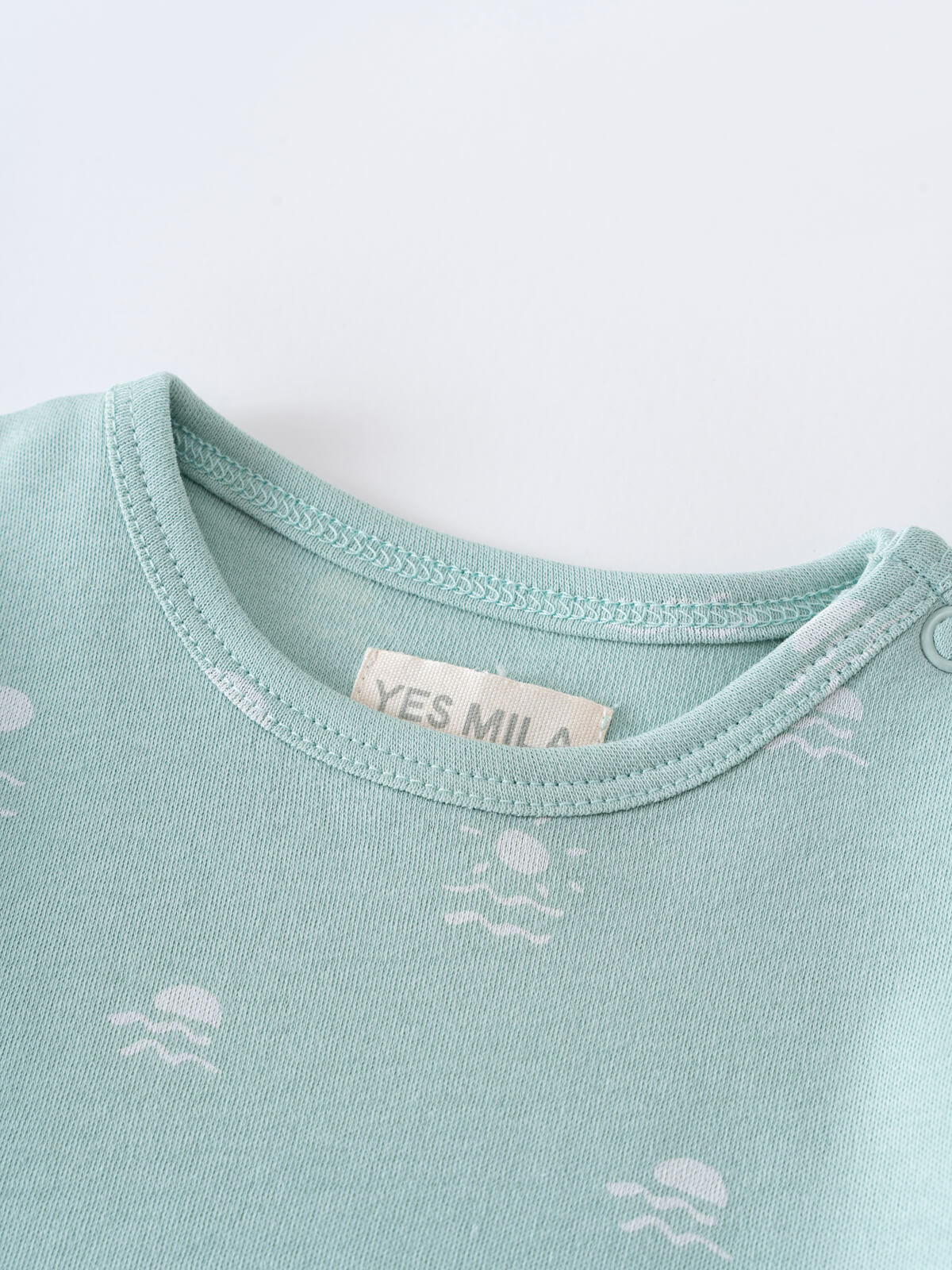 Close-up of a light blue bodysuit neckline with small white printed patterns Matt Short Sleeve Bodysuit - Summer Time Baby boy