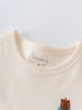 Close-up of cream colored t-shirt collar with embroidered bear detail Feature Print Short Sleeve Tee - Hiking Bear Boys