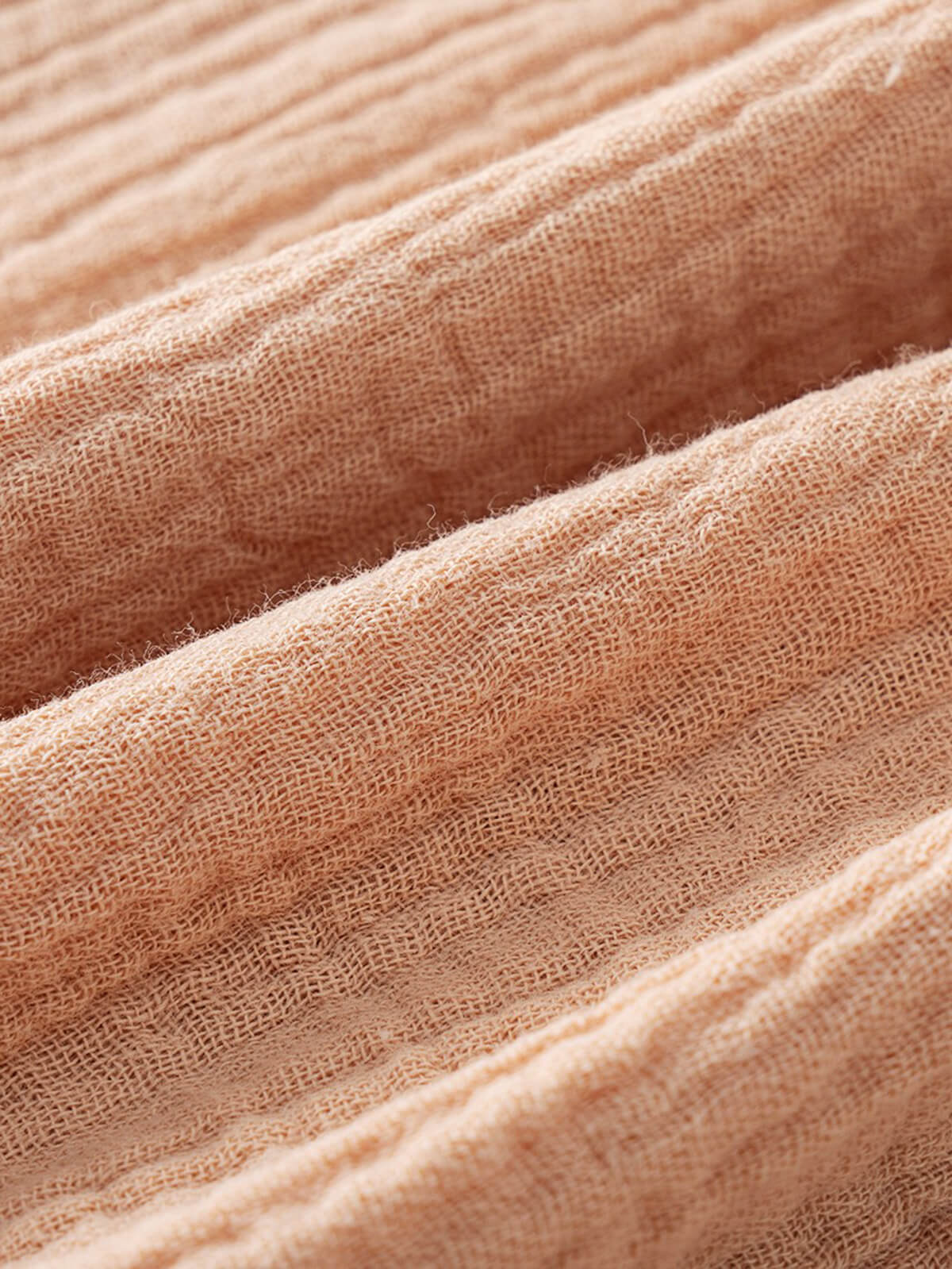 Close-up of peach-colored woven fabric with visible texture and soft folds Muslin Long Sleeve Shirt - Sand Boys