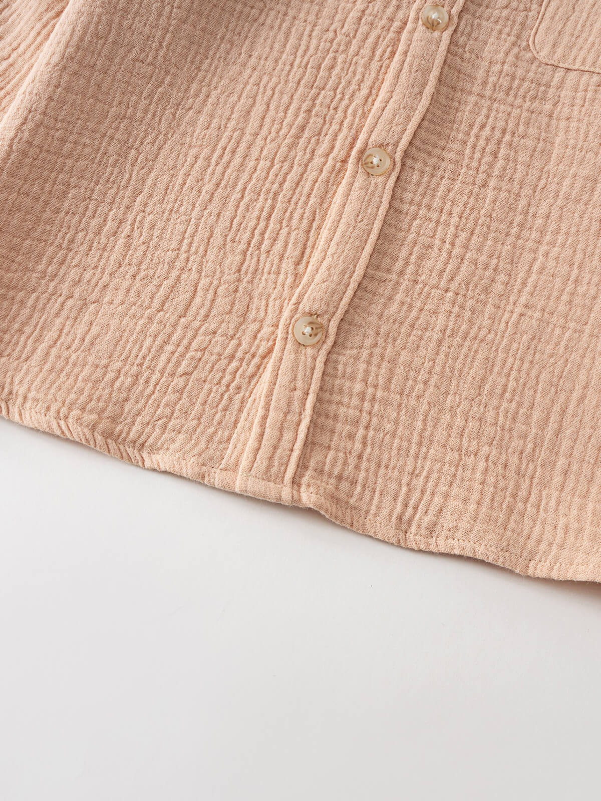 Close-up of a beige textured shirt with buttons and pocket detail Muslin Long Sleeve Shirt - Sand Boys
