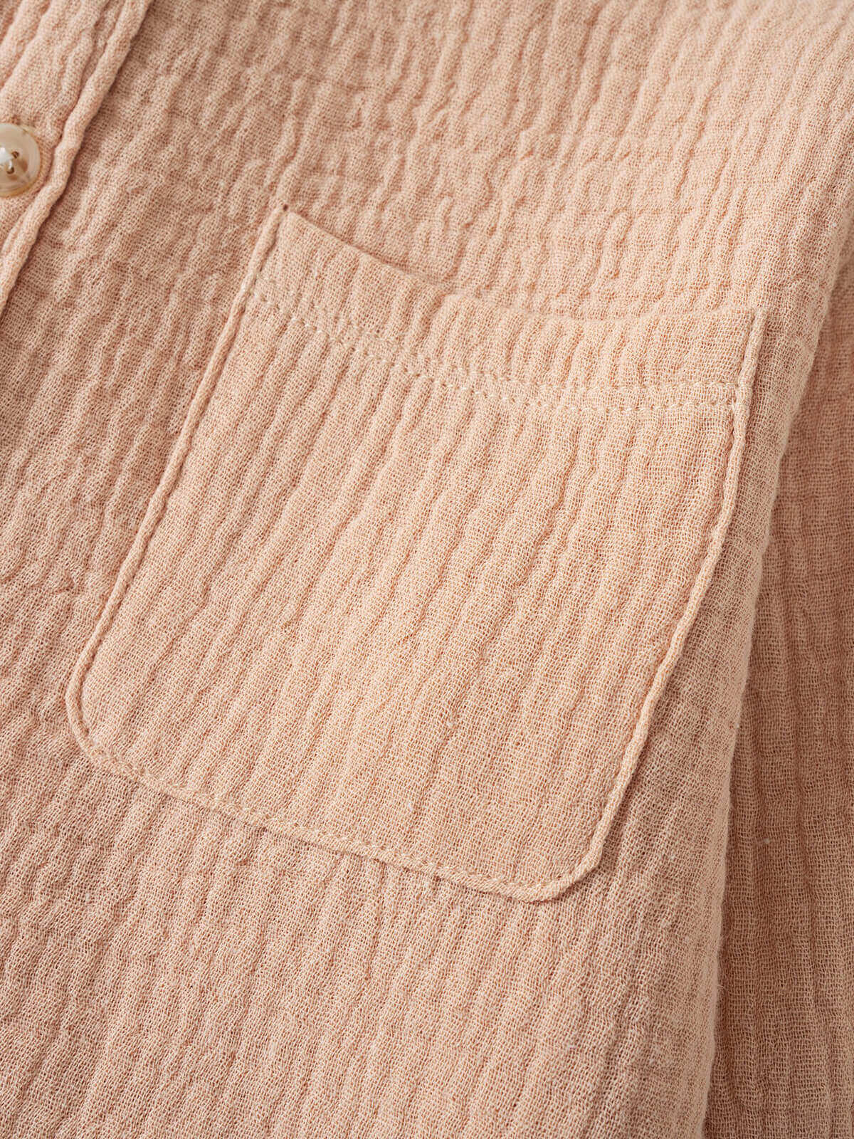 Close-up of a textured beige fabric shirt showing a pocket detail Muslin Long Sleeve Shirt - Sand Boys