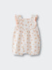 White romper with orange floral print and ruffled sleeves on light background Muslin Romper - Petal Paws Baby girl