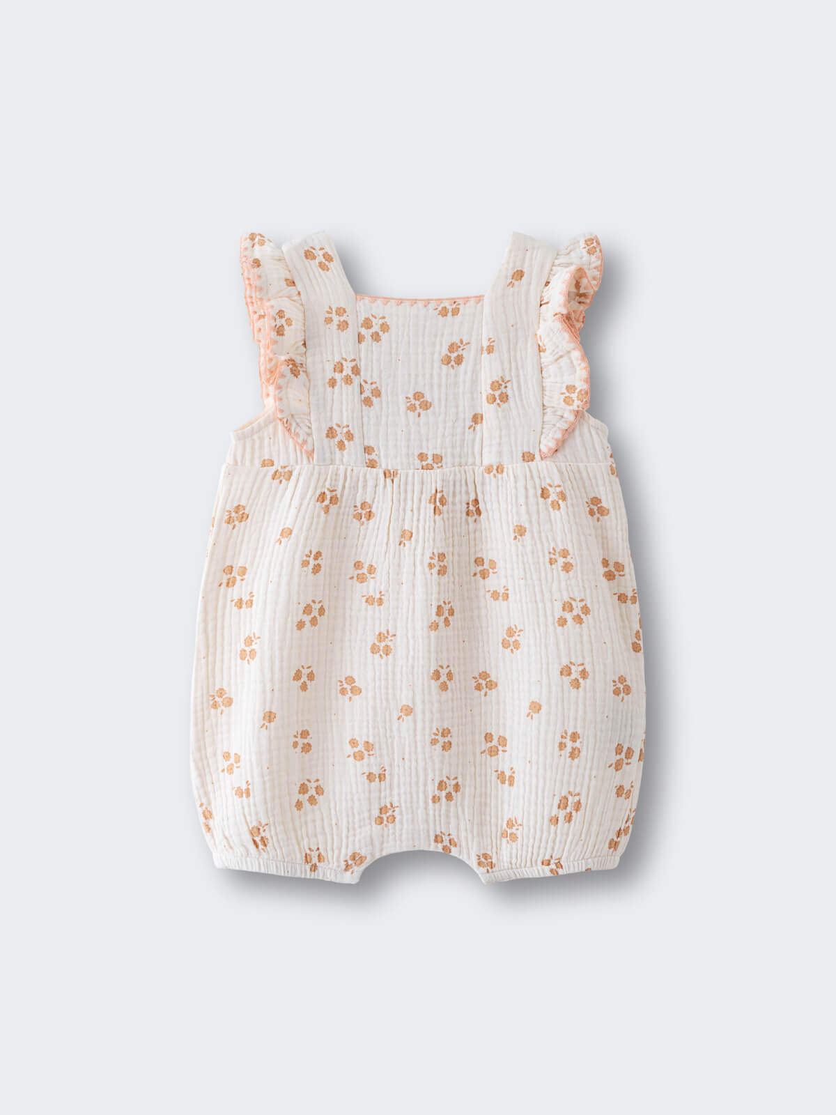 White romper with orange floral print and ruffled sleeves on light background Muslin Romper - Petal Paws Baby girl